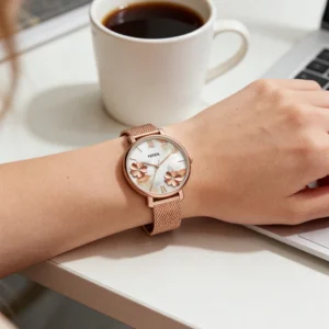Rose gold watch on wrist.