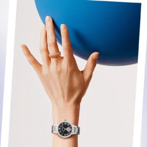 Woman's wrist with watch and balloon
