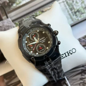 Black chronograph watch on cushion