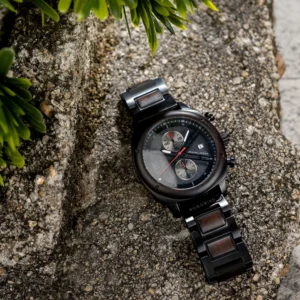 Wooden band chronograph watch on rock