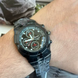 Black chronograph watch on wrist
