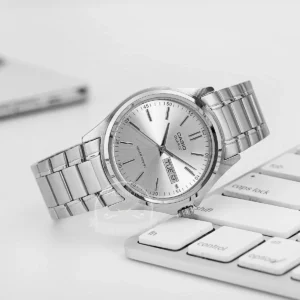 Silver watch on keyboard