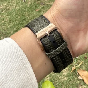 Green woven watch strap.