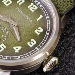 Green dial wristwatch close-up