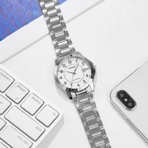 Silver analog watch on desk