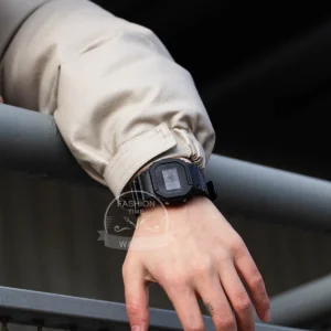 Black digital watch on wrist