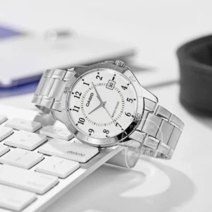 Silver watch on keyboard